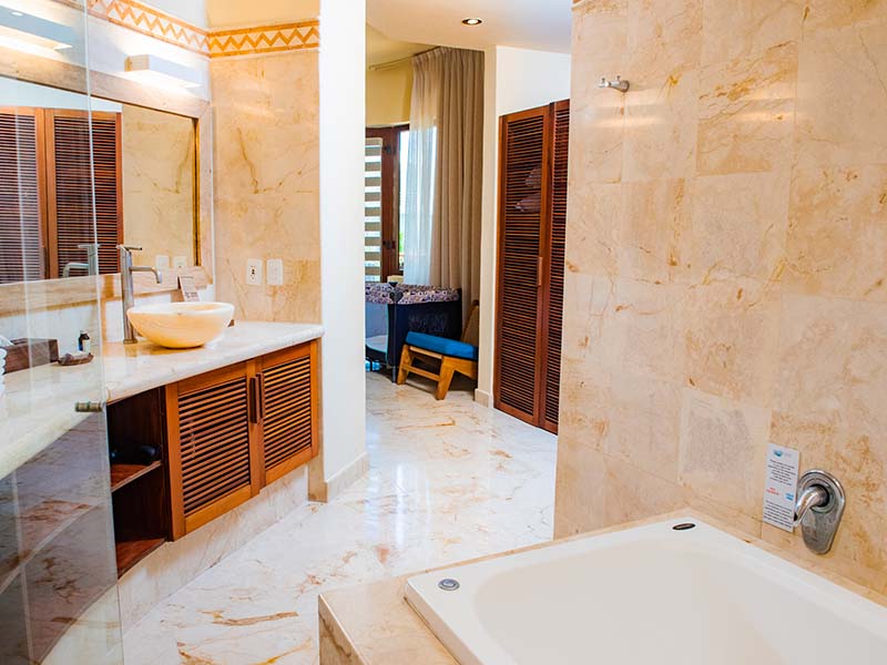 Condo 207 exterior framed by lush garden walkway