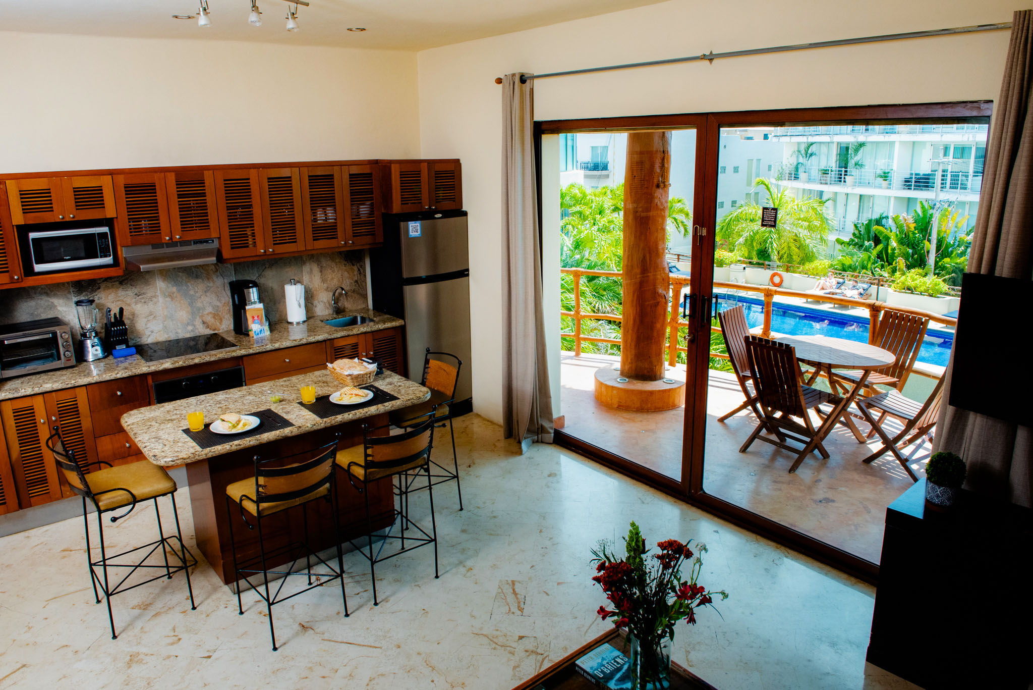 Porto Playa Condo 217 – elegant living room with handcrafted décor and garden views